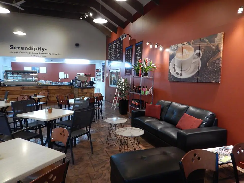Inside: red walls, timber rafters, blackboard menus and a black leather couch